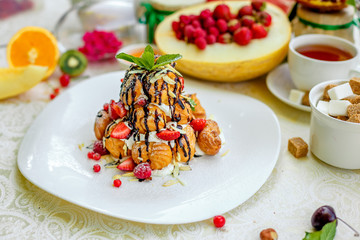 Krekembush - an elegant French profiterole cake topped with chocolate and nuts