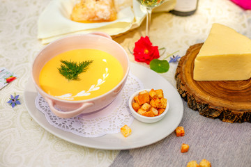 cheese soup with crackers on the holiday table