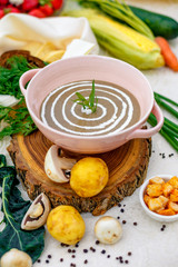 mushroom soup with vegetables and herbs on the table
