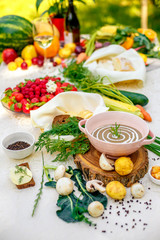 mushroom soup with vegetables and herbs on the table