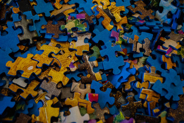 Close-up of colorful pieces of puzzle. Stack of Puzzle Pieces. Puzzle pieces. Puzzle figures....