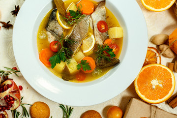 Russian soup with fish in a plate and ingredients served on the table