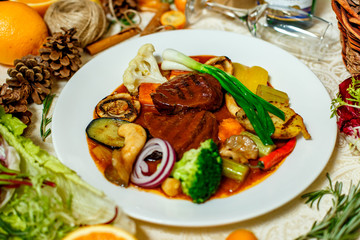 juicy steaks with grilled broccoli vegetables and mushrooms served on the table