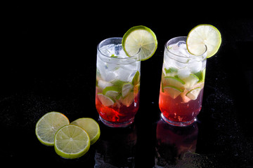 Campari drink with silver rum with ice and lemon