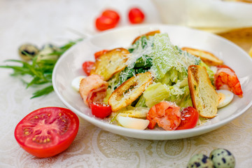 Caesar salad with seafood vegetables and herbs, healthy food on the table