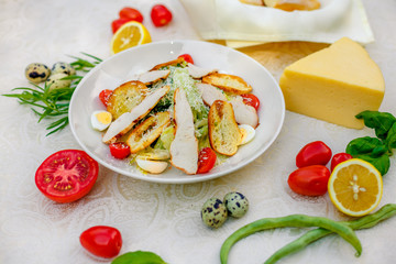 Caesar salad with chicken vegetables and herbs, healthy food on the table