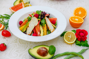 salad with chicken vegetables and herbs, healthy food on the table