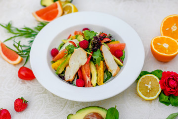 salad with chicken vegetables and herbs, healthy food on the table