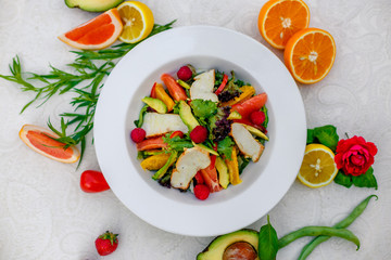 salad with chicken vegetables and herbs, healthy food on the table