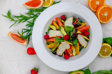 salad with chicken vegetables and herbs, healthy food on the table