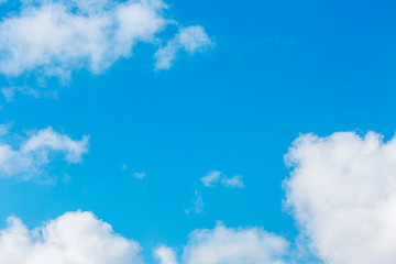 Bright clear blue sky with cumulus clouds. Space for text. Background.