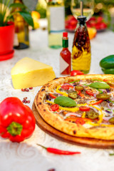 Delicious italian pizza served on table with ingredients cheese and vegetables