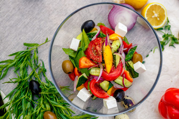 fresh vegetarian salad with greens and vegetables on the table, healthy food