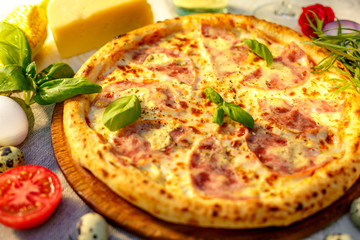 Delicious italian pizza served on table with ingredients cheese and vegetables