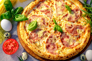 Delicious italian pizza served on table with ingredients cheese and vegetables