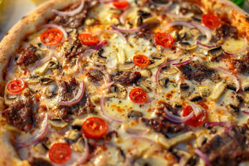 Delicious italian pizza served on table with ingredients cheese and vegetables