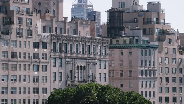 Panning shot of the Fifth Avenue building facades on the east border of the Central Park in New York