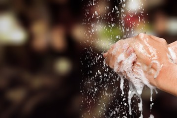 Naklejka na ściany i meble Human washing hands in clean water with soap