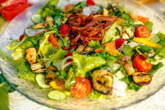 Fresh salad with dried meat, herbs and vegetables served on the table with the ingredients, healthy food