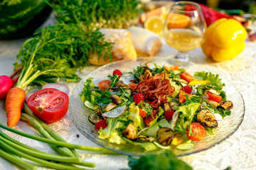 Fresh salad with dried meat, herbs and vegetables served on the table with the ingredients, healthy food