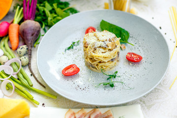 Italian pasta carbonara served on a table with ingredients