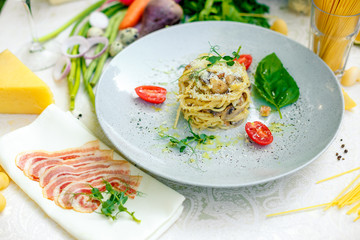 Italian pasta carbonara served on a table with ingredients