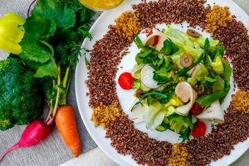 salad with red quinoa and chicken breast with tomatoes served on the table with ingredients, healthy food