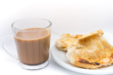 Popular brazilian bread with melted butter called pao na chapa. Pao na chapa traditional brazilian breakfast. Glass of hot coffee with milk called pingado. 