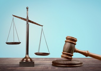 Law scales and gavel on wooden table. Symbol of justice