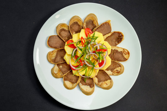 Kazakh cuisine, meat with boiled potatoes onions and herbs, on a white plate