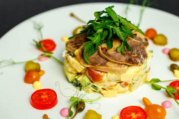 salad with meat and ingredients on a white plate