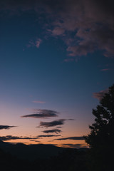 Fototapeta na wymiar sunset sky over the hills and mountains in Tasmania, Australia with deep tones