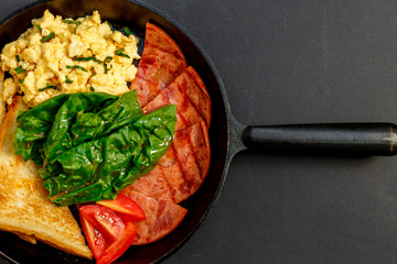 delicious omelet with bacon greens and toast in a pan, breakfast