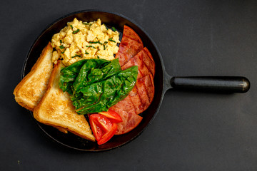 delicious omelet with bacon greens and toast in a pan, breakfast