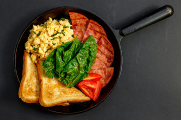 delicious omelet with bacon greens and toast in a pan, breakfast