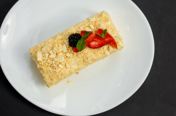 a slice of honey cake with berries, sweet dessert