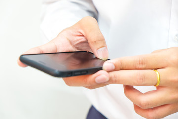 Business man hand use smartphone on white background close up on hand