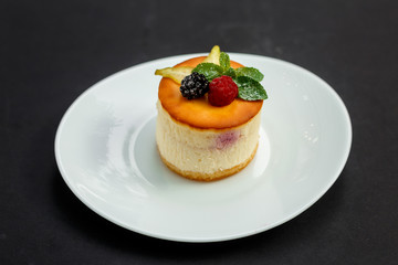delicious cheesecake with raspberry flavor with berries, powdered sugar and mint, dessert