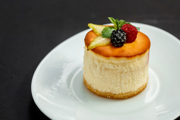 delicious cheesecake with raspberry flavor with berries, powdered sugar and mint, dessert