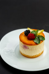 delicious cheesecake with raspberry flavor with berries, powdered sugar and mint, dessert