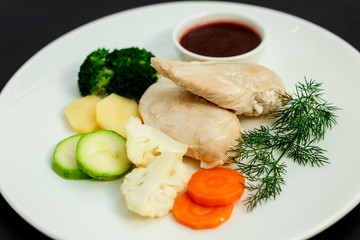 boiled chicken breast with vegetables and sauce, healthy food