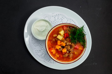 hot soup with broth and stew with vegetables