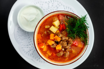 hot soup with broth and stew with vegetables