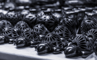 Close up of turtle handicrafts made of traditional black mud