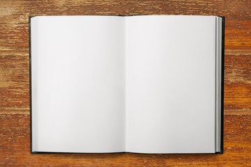 Open blank notebook on a wooden desk