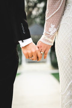 Bride and Groom Holding Hands with Wedding Rings