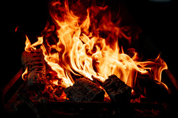 Flame of burning logs in the fireplace