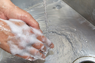 Fototapeta premium A Man's Hands with Soap and Water on Them