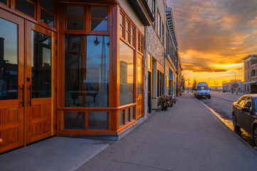 Sunset reflected in store front windows of Fort MacLeod, Alberta, Canada