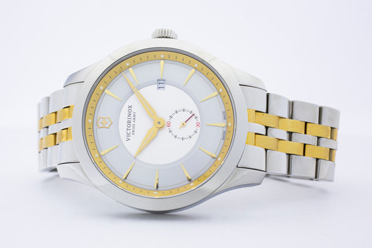 Ibach, Switzerland 31.03.2020 - The close up of Victorinox woman watch stainless steel case stainless steel bracelet gold PVD coating white clock face dial swiss quartz mechanical watch swiss made